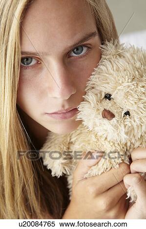 Unhappy teenage girl with cuddly toy View Large Photo Image Stock Photography - Unhappy teenage girl with cuddly toy. Fotosearch