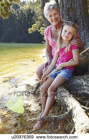 Woman and girl fishing together View Large Photo Image Stock Photo - Woman and girl fishing together. Fotosearch