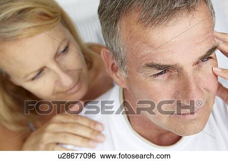 Stock Photograph - Woman comforting anxious husband. Fotosearch