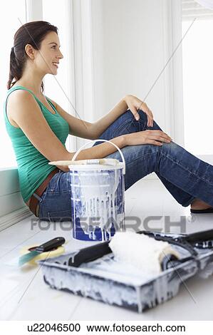 Stock Image - Woman decorating house. Fotosearch