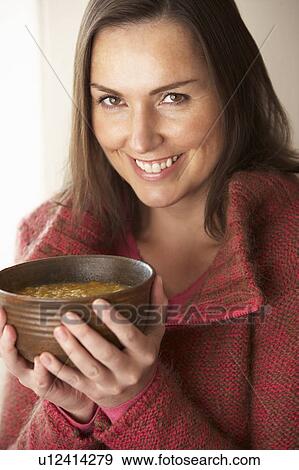 Stock Photo - Woman holding bowl of soup. Fotosearch