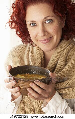 Stock Photo - Woman holding bowl of soup. Fotosearch