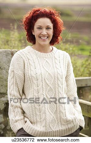 Stock Image - Woman in countryside. Fotosearch