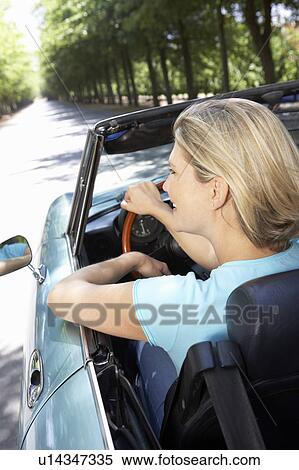 Stock Photography - Woman in sports car. Fotosearch