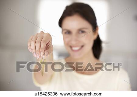 Stock Photograph - Woman moving into new home. Fotosearch