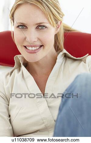 Woman sitting in chair View Large Photo Image Stock Photo - Woman sitting in chair. Fotosearch