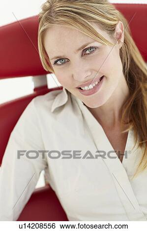 Stock Photograph - Woman sitting in chair. Fotosearch