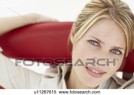 Stock Photography - Woman sitting in chair. Fotosearch