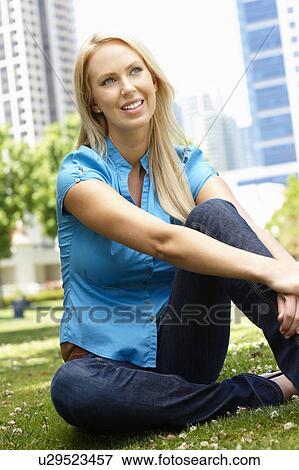 Stock Photo - Woman sitting in city park. Fotosearch