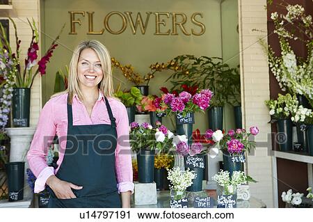Woman standing outside florist View Large Photo Image Stock Image - Woman standing outside florist. Fotosearch