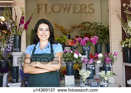 Woman standing outside florist View Large Photo Image Stock Photo - Woman standing outside florist. Fotosearch
