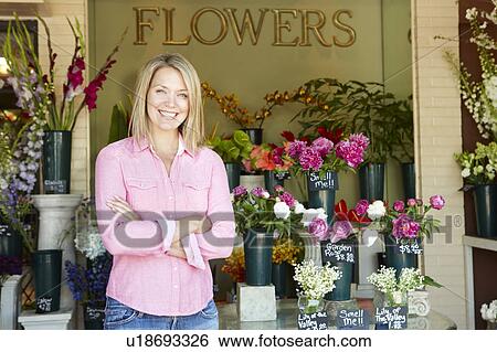 Woman standing outside florist View Large Photo Image Stock Photograph - Woman standing outside florist. Fotosearch