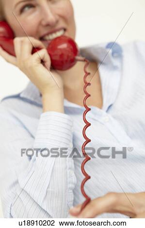 Stock Image - Woman talking on telephone. Fotosearch