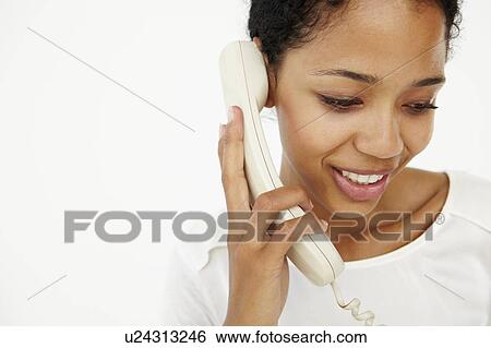 Stock Photograph - Woman talking on telephone. Fotosearch