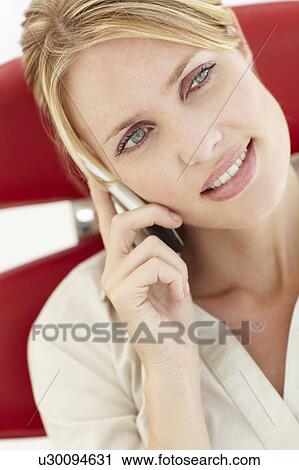 Stock Image - Woman talking on the phone. Fotosearch