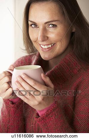 Woman with hot drink View Large Photo Image Stock Photograph - Woman with hot drink. Fotosearch