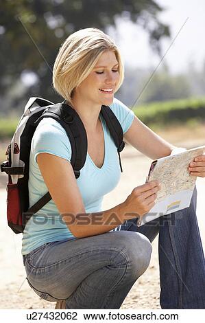 Stock Image - Woman with map on country walk. Fotosearch