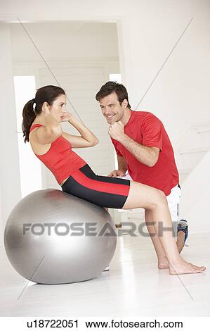 Woman with personal trainer in home gym View Large Photo Image Stock Image - Woman with personal trainer in home gym. Fotosearch