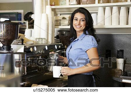 Stock Photography - Woman working in coffee shop. Fotosearch