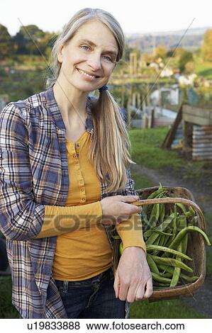 Stock Photo - Woman working on allotment. Fotosearch