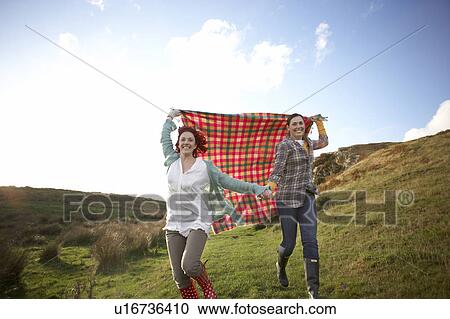 Stock Image - Women in countryside. Fotosearch