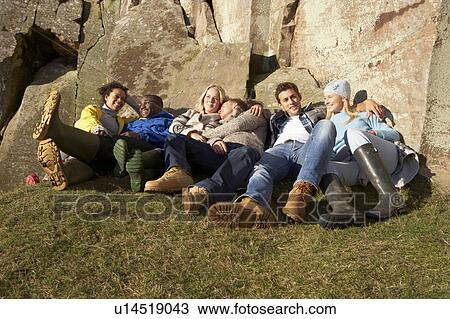 Stock Image - Young adults in countryside. Fotosearch
