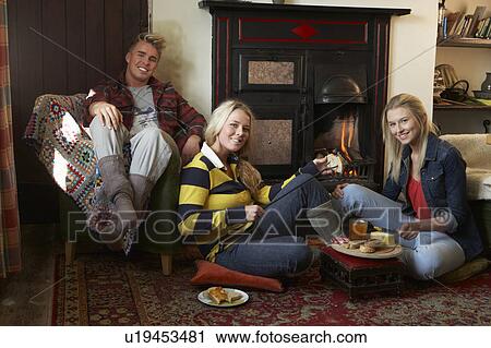Young adults making toast on open fire View Large Photo Image Stock Image - Young adults making toast on open fire. Fotosearch