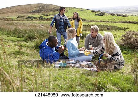 Stock Image - Young adults on country picnic. Fotosearch