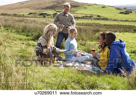Young adults on country picnic View Large Photo Image Stock Image - Young adults on country picnic. Fotosearch