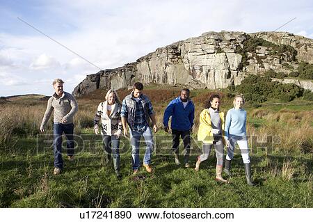 Young adults on country walk View Large Photo Image Stock Image - Young adults on country walk. Fotosearch