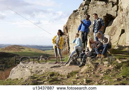Young adults on country walk View Large Photo Image Stock Photo - Young adults on country walk. Fotosearch