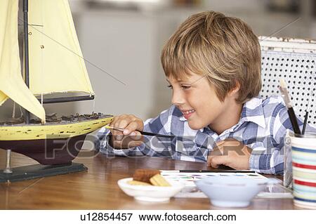 Young boy making model ship View Large Photo Image Stock Photo - Young boy making model ship. Fotosearch