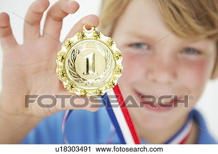 Young boy showing off medal View Large Photo Image Stock Image - Young boy showing off medal. Fotosearch