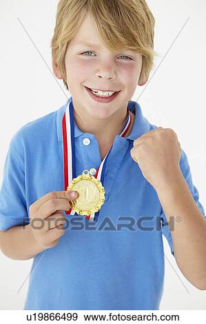 Young boy showing off medal View Large Photo Image Stock Photo - Young boy showing off medal. Fotosearch