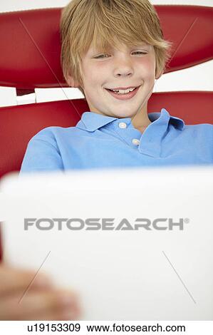 Stock Photo - Young boy using laptop. Fotosearch