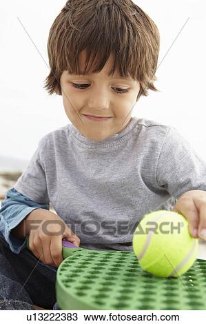 Stock Image - Young boy with bat and ball. Fotosearch