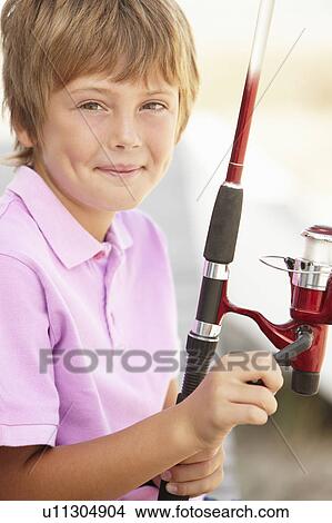 Young boy with fishing rod View Large Photo Image Picture - Young boy with fishing rod. Fotosearch
