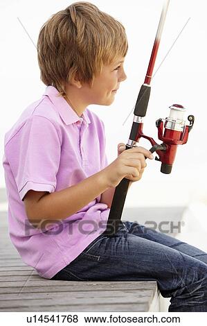 Stock Photo - Young boy with fishing rod. Fotosearch