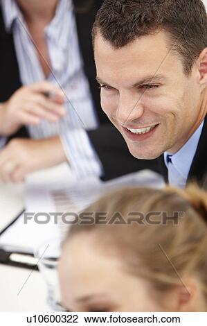 Young businessman in meeting View Large Photo Image Stock Image - Young businessman in meeting. Fotosearch