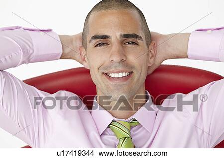 Young businessman relaxing in chair View Large Photo Image Picture - Young businessman relaxing in chair. Fotosearch