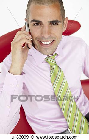 Stock Image - Young businessman using cellphone. Fotosearch