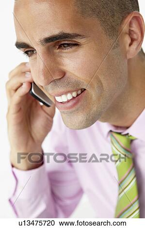 Young businessman using cellphone View Large Photo Image Stock Image - Young businessman using cellphone. Fotosearch