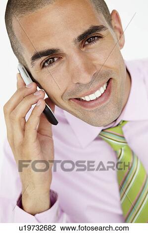 Stock Image - Young businessman using cellphone. Fotosearch