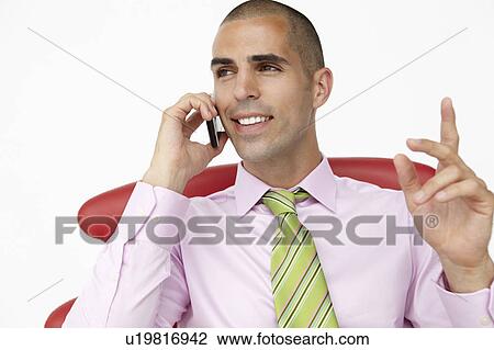 Young businessman using cellphone View Large Photo Image Stock Image - Young businessman using cellphone. Fotosearch