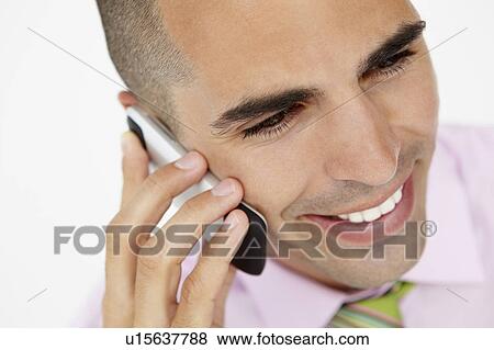 Stock Photo - Young businessman using cellphone. Fotosearch