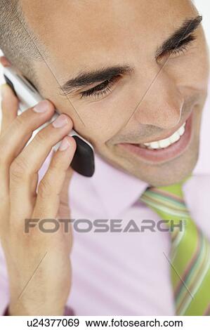 Stock Photo - Young businessman using cellphone. Fotosearch