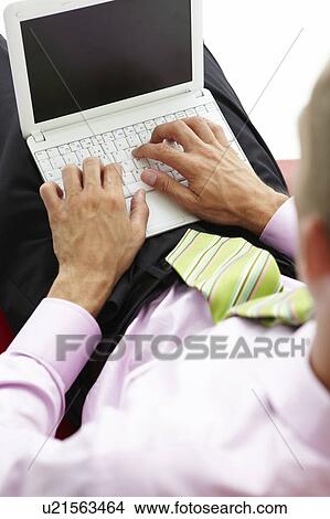 Young businessman using laptop View Large Photo Image Picture - Young businessman using laptop. Fotosearch