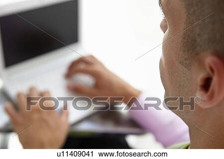 Young businessman using laptop View Large Photo Image Stock Image - Young businessman using laptop. Fotosearch