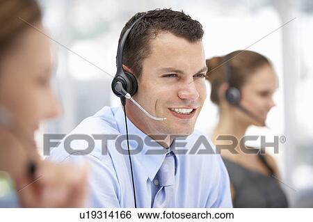 Young businessman wearing headset View Large Photo Image Stock Photograph - Young businessman wearing headset. Fotosearch