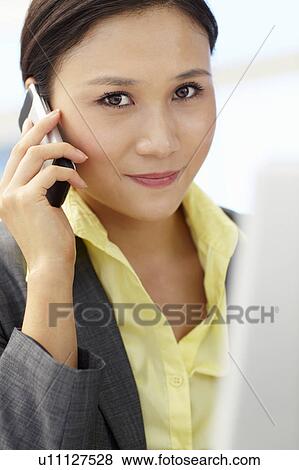 Stock Photo - Young businesswoman at work. Fotosearch